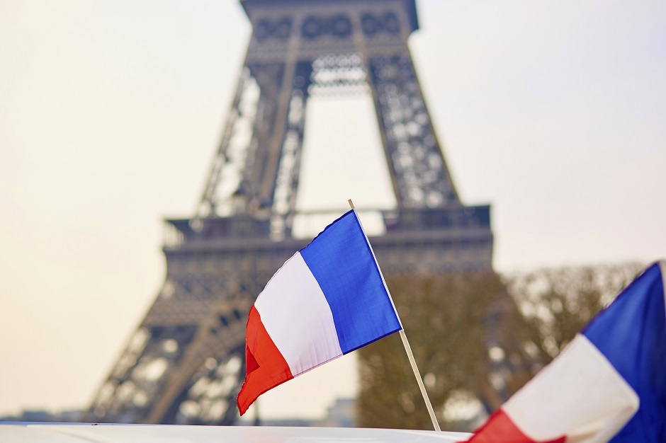French national flag (tricolour) in Paris with the Eiffel tower in the background